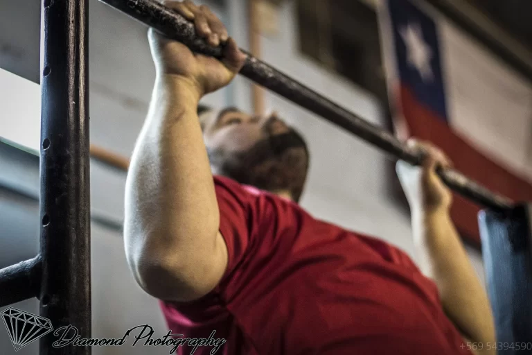 athlete training with weights in a gym representing a split workout routine