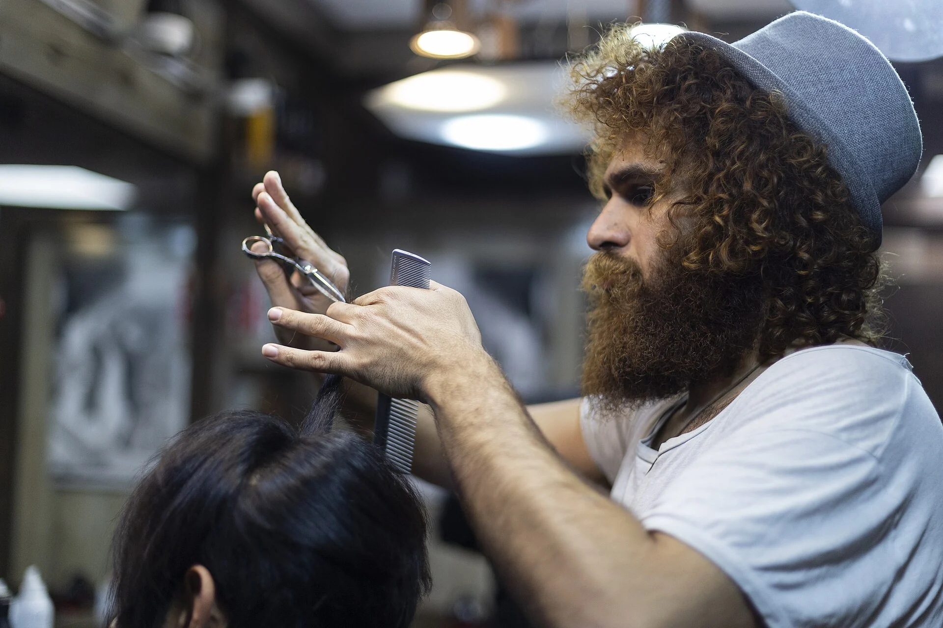 barber trimming and shaping a man beard