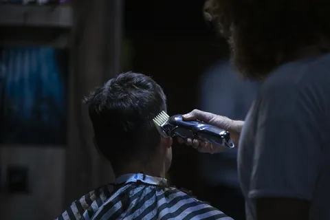 barber shaping a fade representing a beard fade cut