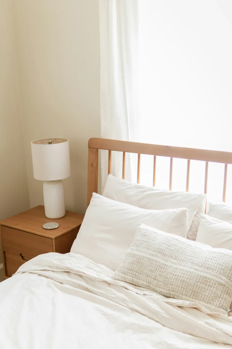 bright bedroom white bedding wooden headboard nightstand illustrating caffeine vs naps