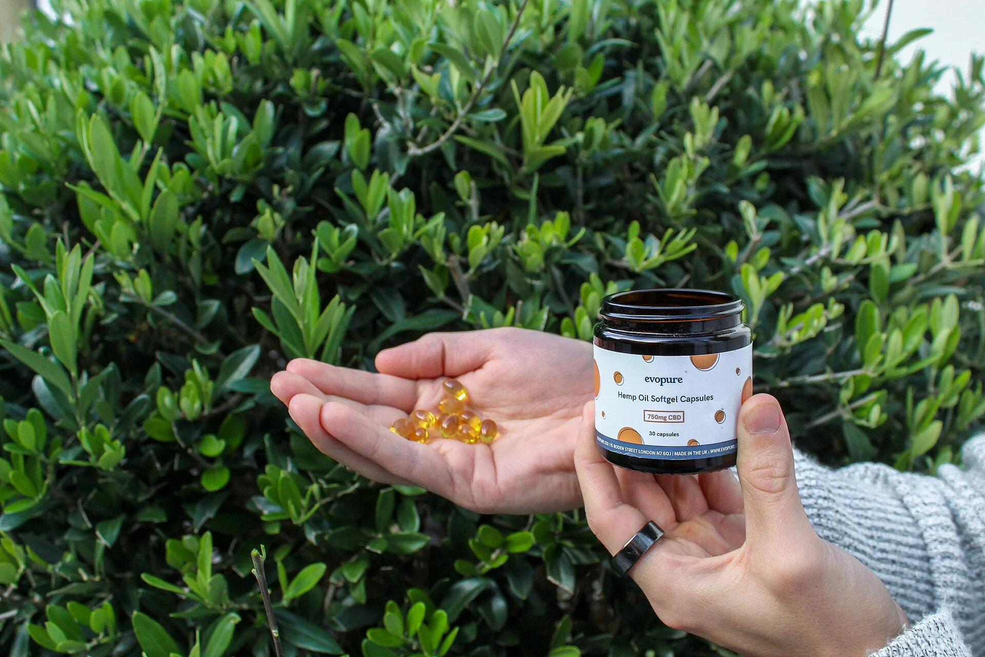 CBD oil capsules and bottle next to sleep and wellness supplements