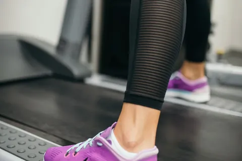 close-up of an athlete running on a treadmill representing zone 2 training