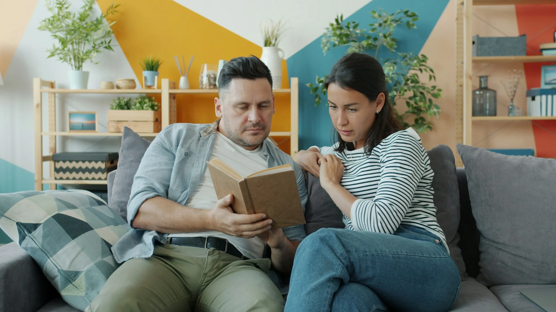 couple reading on a sofa in the evening before bedtime