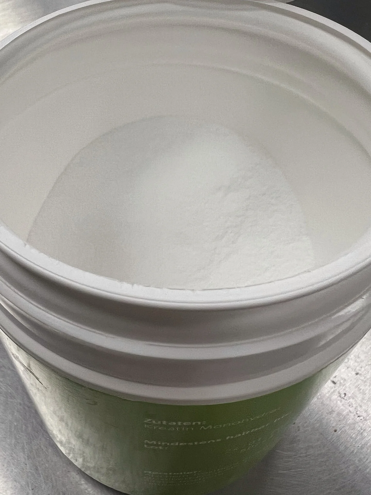 creatine monohydrate powder supplement in a scoop