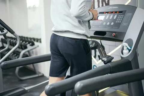 man running on a treadmill representing race conditioning