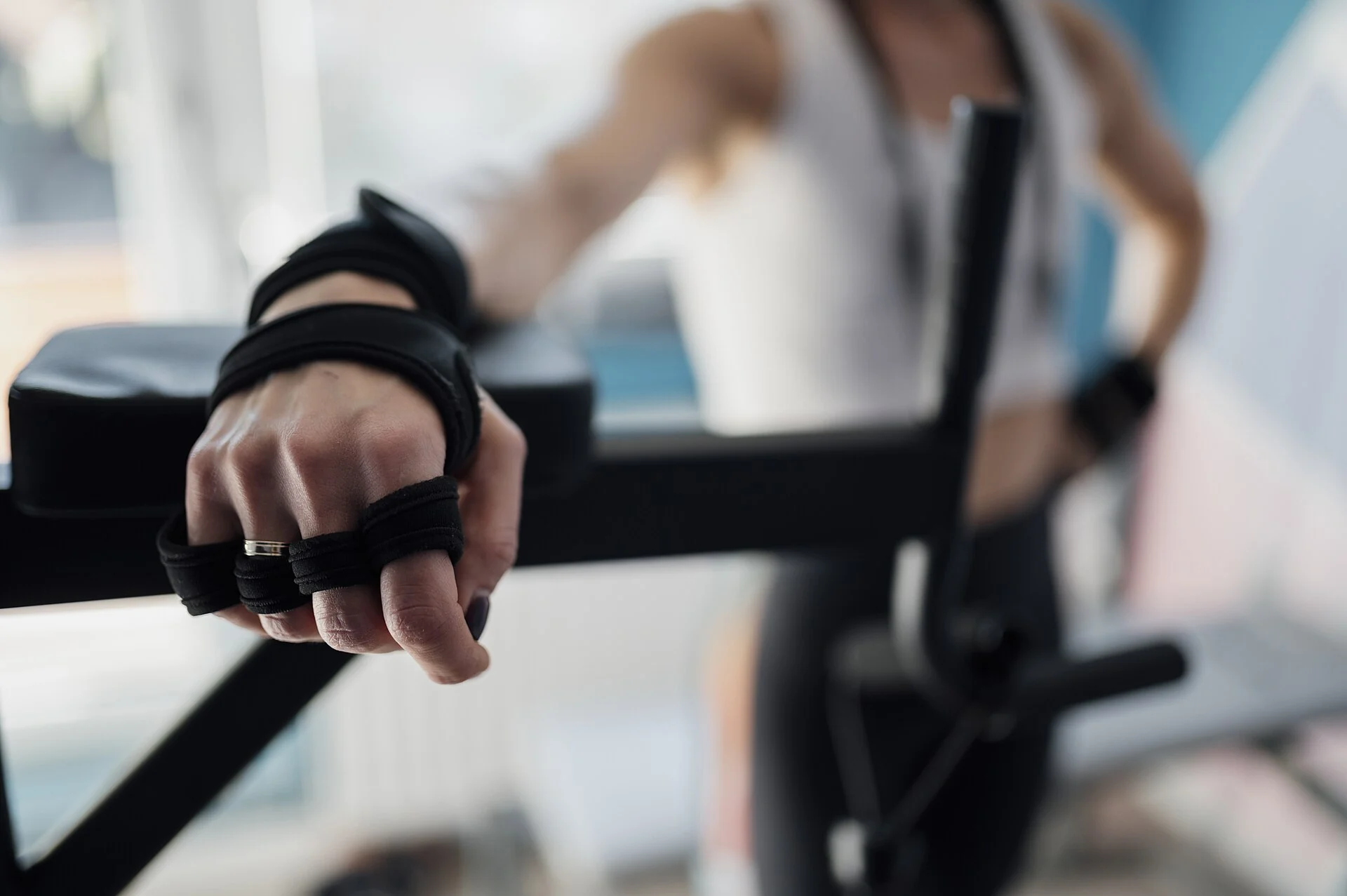 fitness enthusiast preparing strength training workout in modern gym