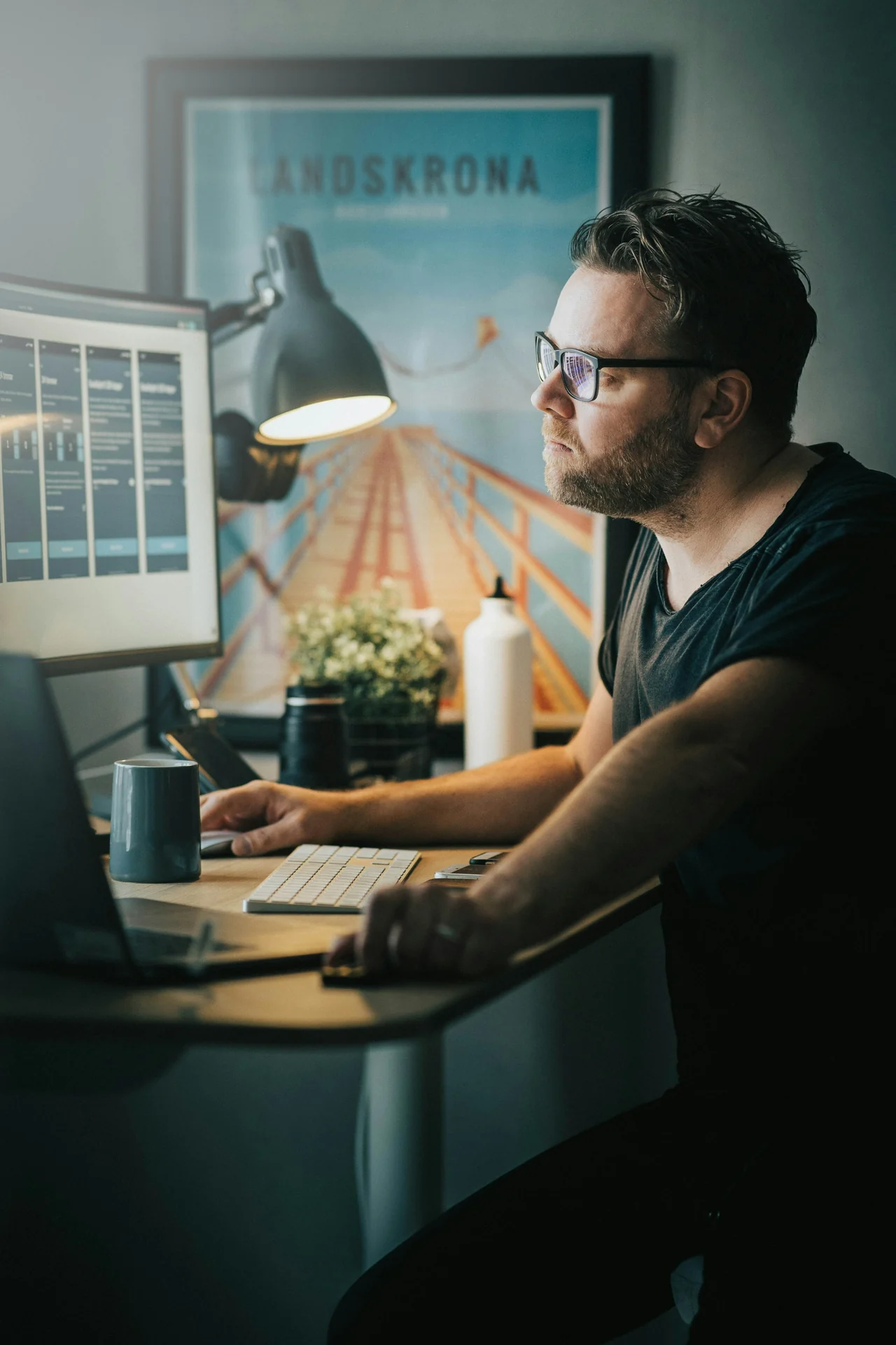 man filling in an online job application at night in a small home office