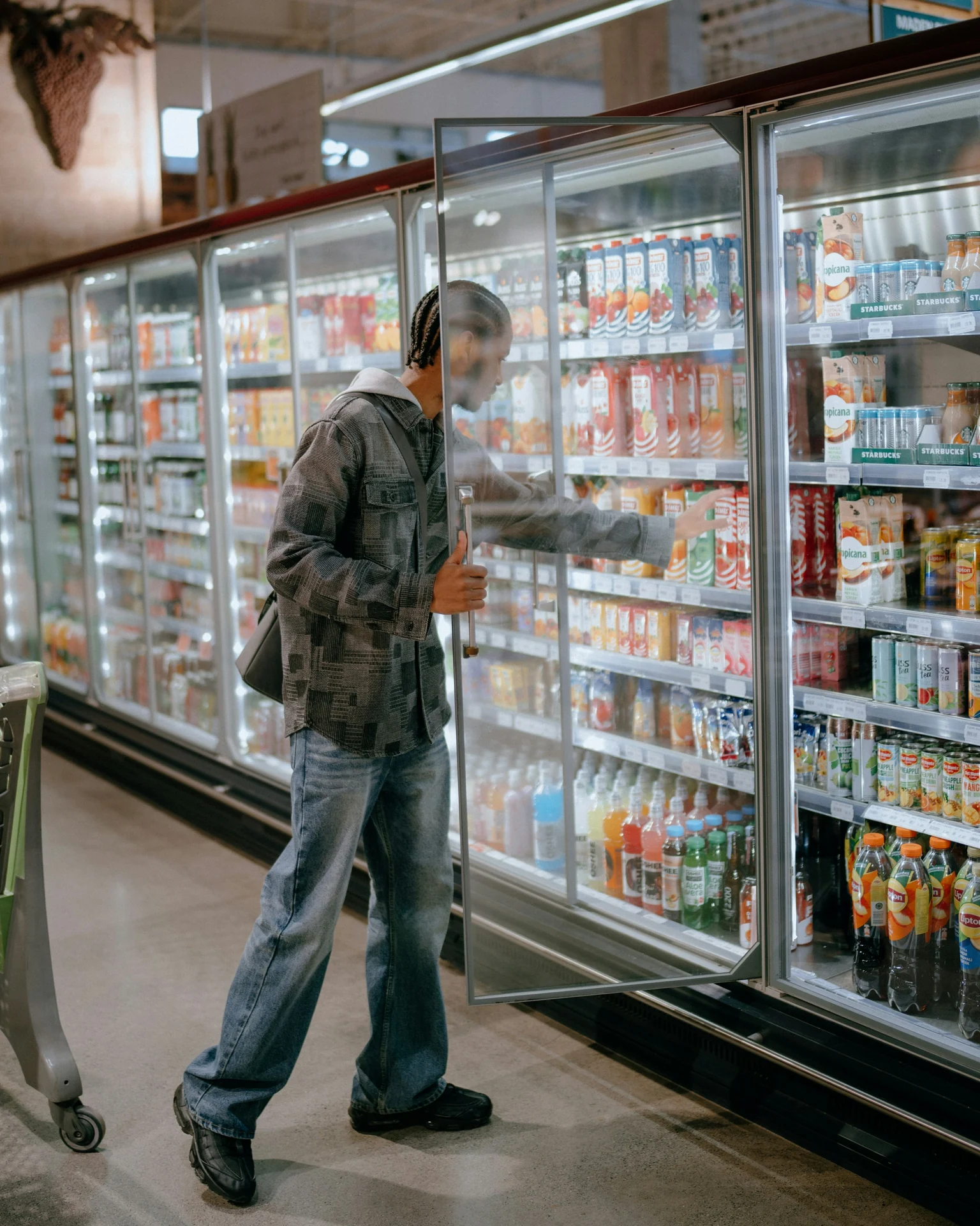 man turning a supplement bottle to read the ingredient label