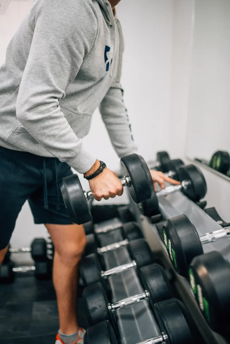 man lifting a dumbbell representing strength training at home