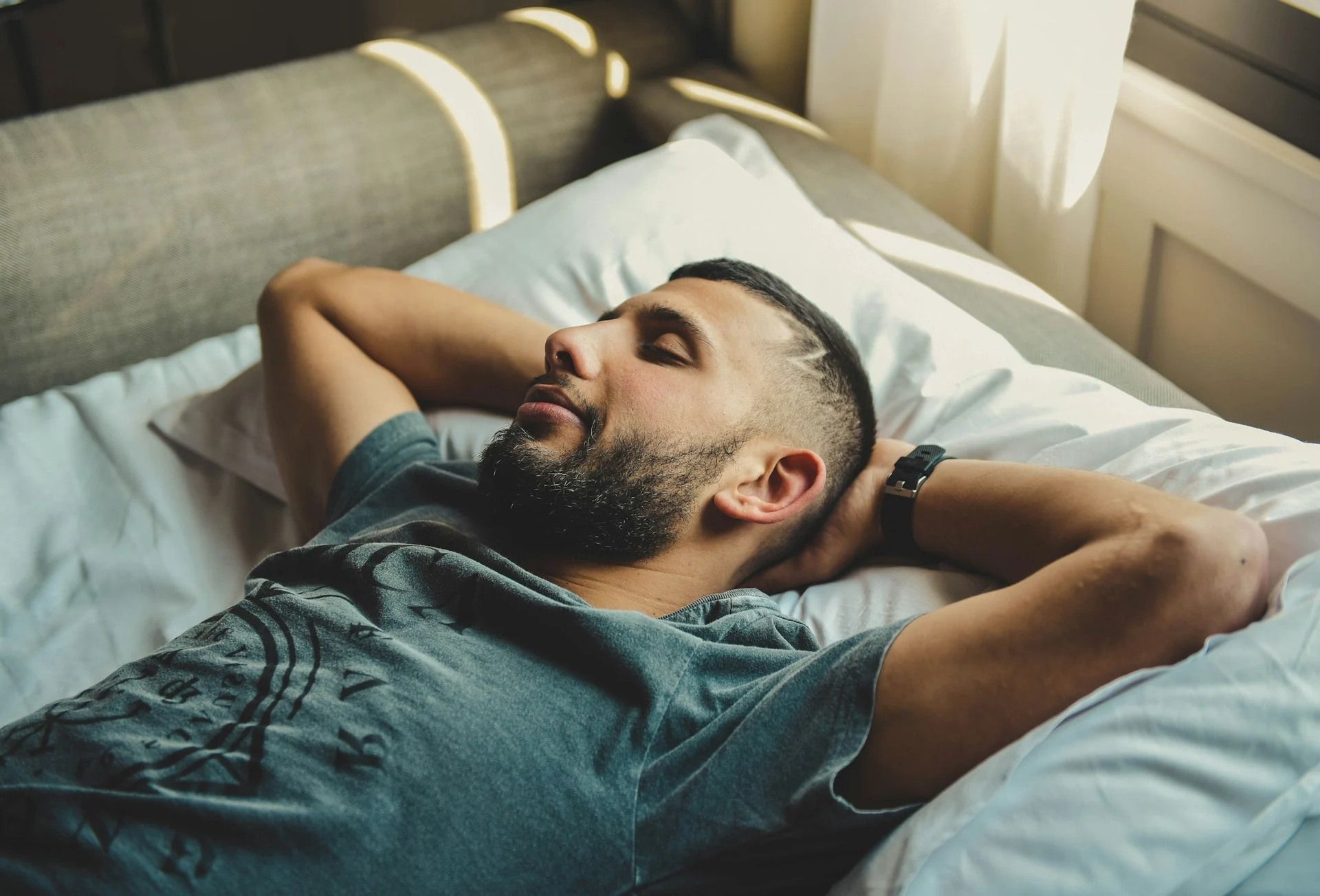 man asleep on his back with his mouth open while snoring