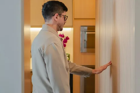 man touching wooden wall modern kitchen background illustrating 5 sleep supplement claims that don't hold up