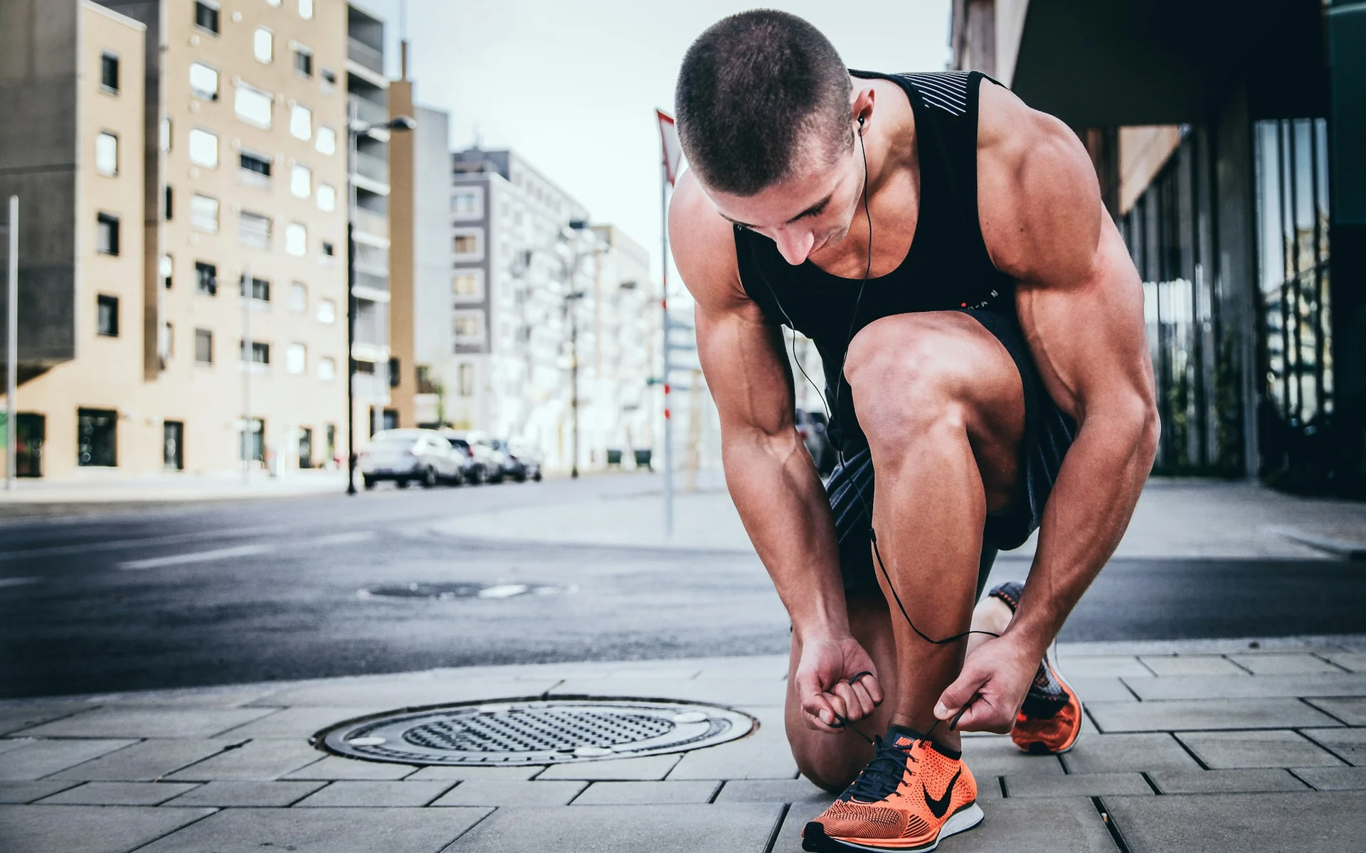 man tying his running shoes before heading out for a morning run