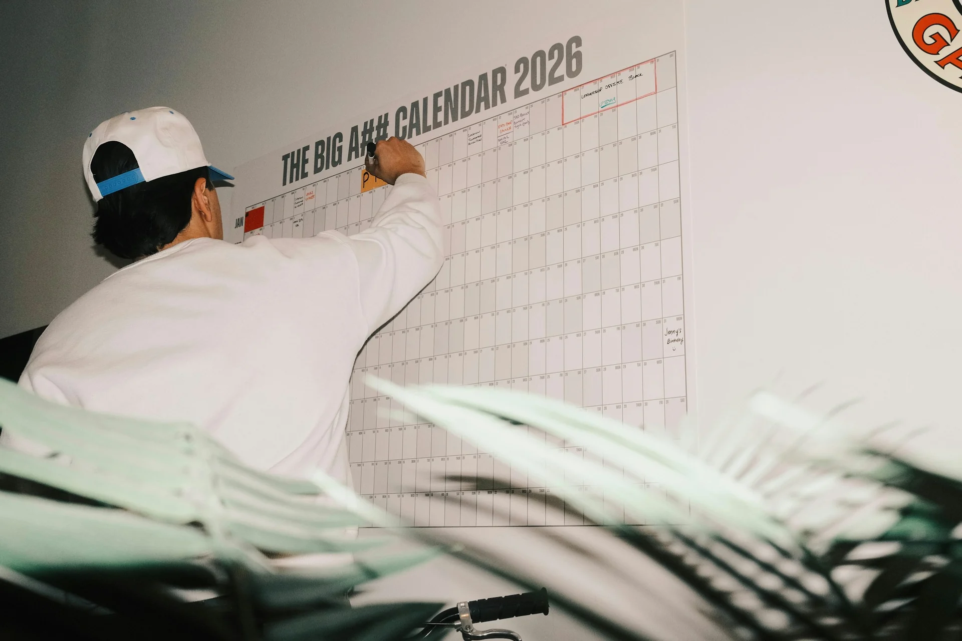 man marking another completed day off a wall calendar