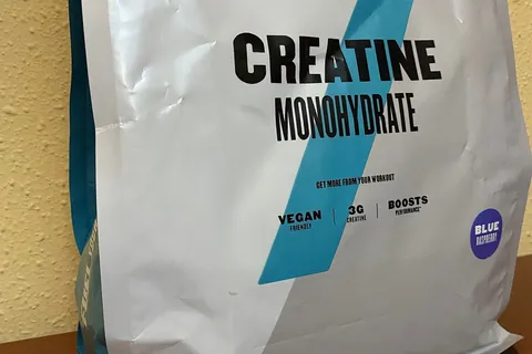 creatine monohydrate powder in a scoop