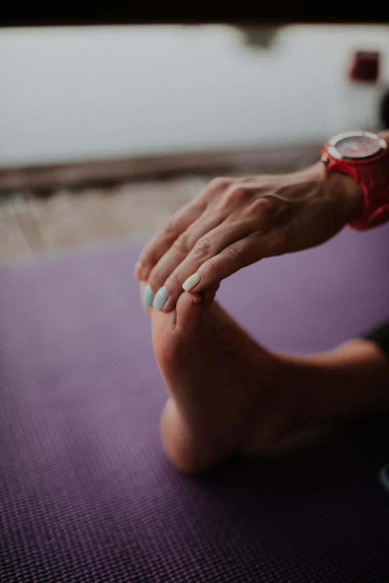 man stretching on a yoga mat in the early morning representing a short morning routine