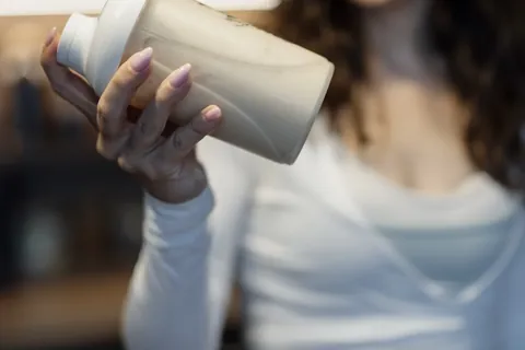 man shaking a protein shaker representing protein intake after 40