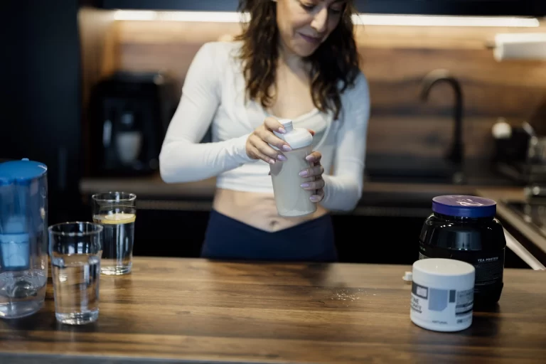 man mixing a protein shake representing a stacked morning habit