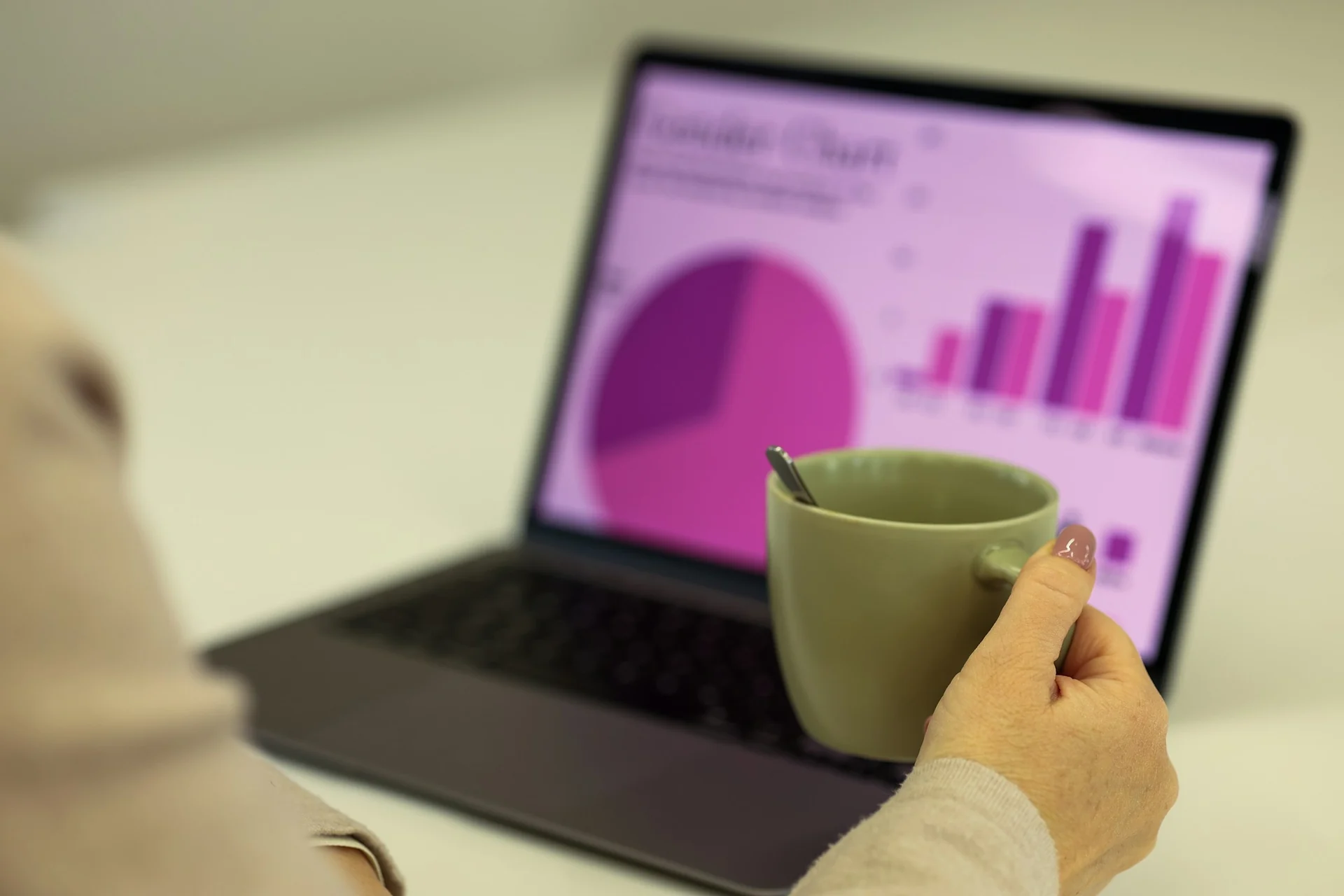 man comparing investment fund fees on a laptop at a desk