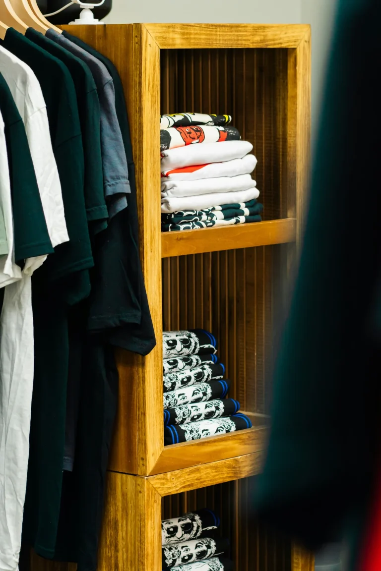 stack folded clothes wooden shelves illustrating chinos vs jeans