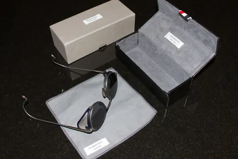 designer sunglasses with their case representing an accessory choice