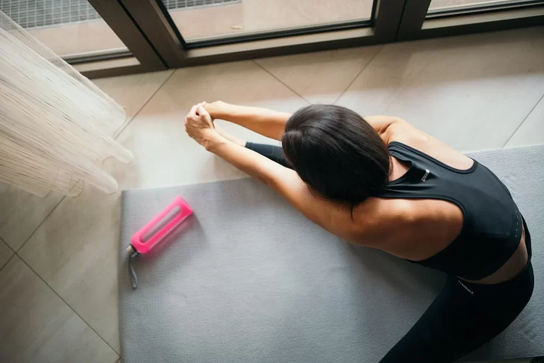 person stretching on a yoga mat representing stress relief